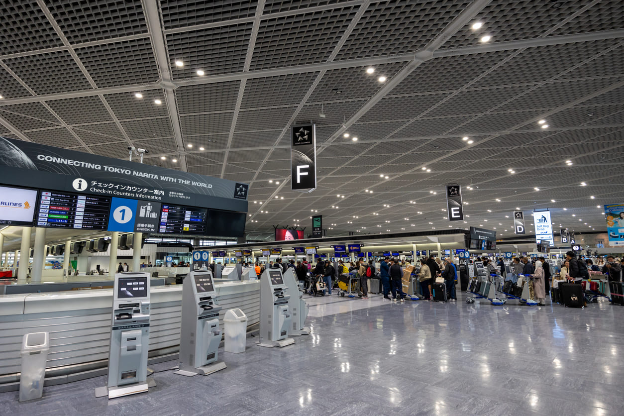 The check-in area at Narita International Airport highlights its modern design, spacious layout, and role as a global aviation hub.