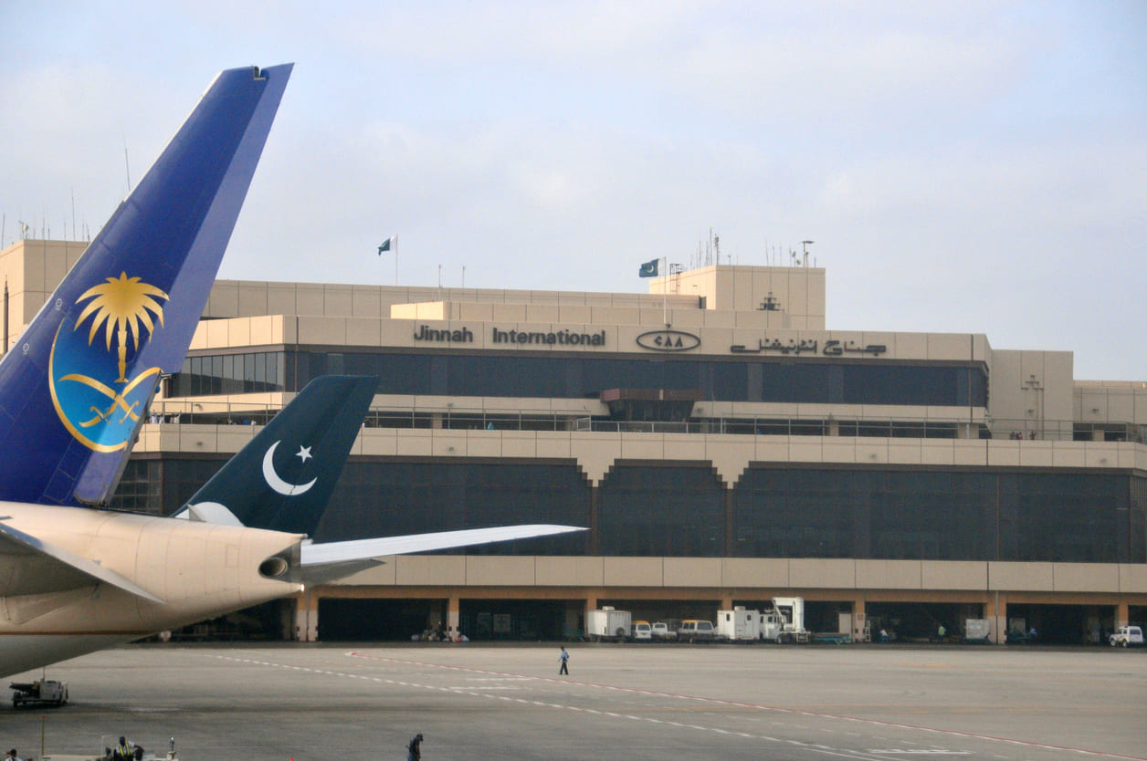 The terminal building of Jinnah International Airport, with prominent airline tail fins, highlights its role as Pakistan's major aviation hub.