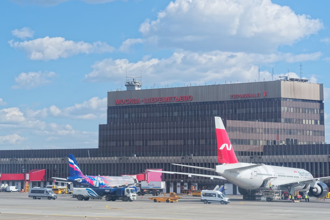 Sheremetyevo International Airport's Terminal F, showcasing its classic architecture with aircraft and ground operations in the foreground.