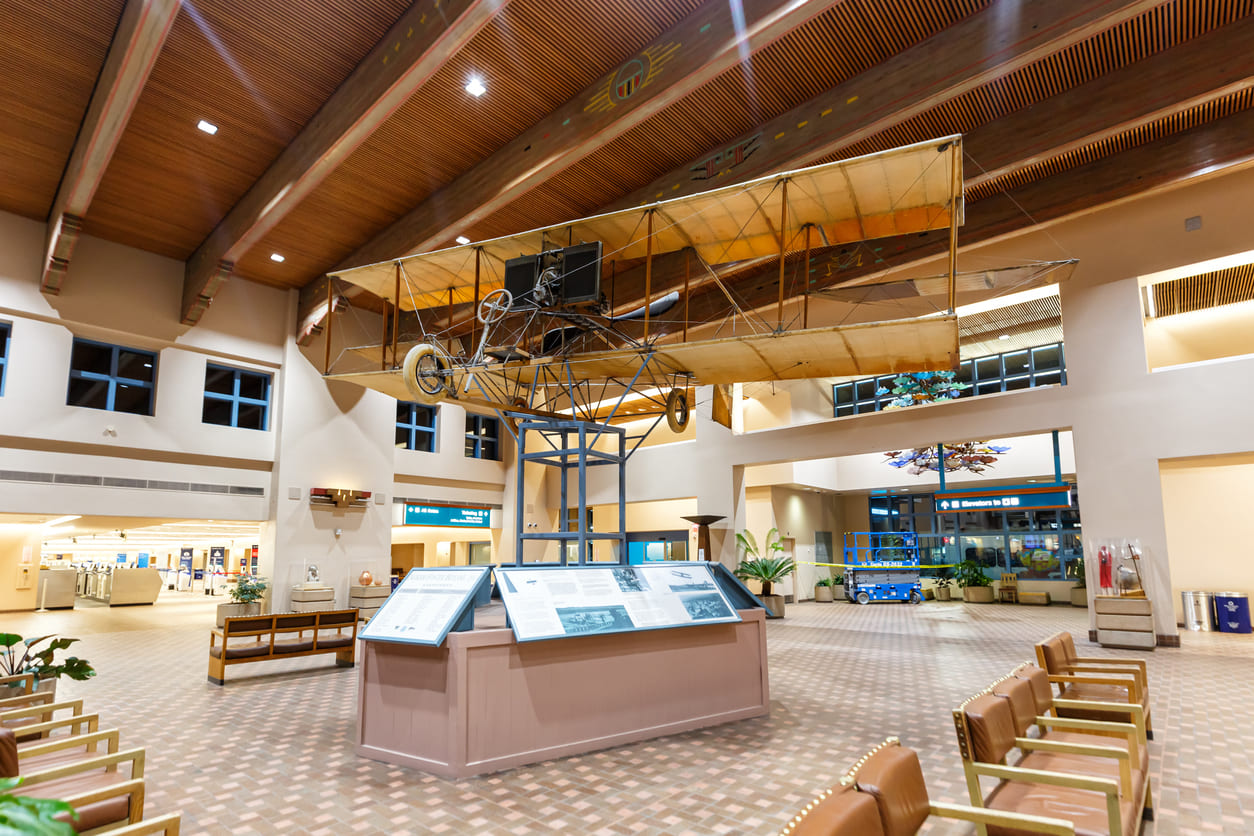 An elegant vintage aircraft suspended inside Albuquerque International Sunport, showcasing its rich aviation heritage.