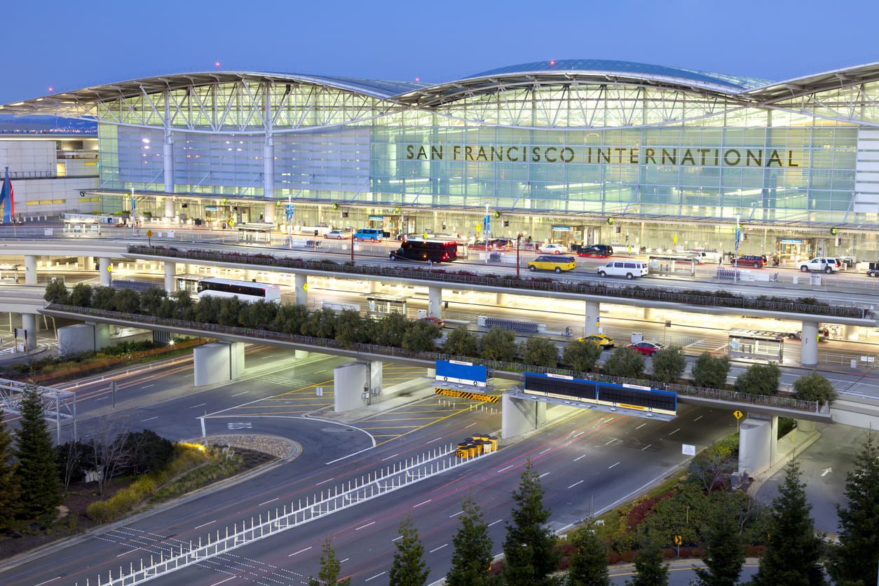 A stunning view of San Francisco International Airport's sleek, modern terminal illuminated at dusk.