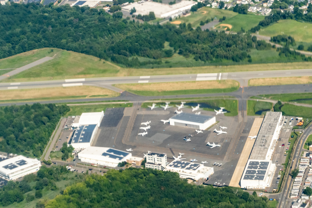 An aerial view of Teterboro Airport highlights its compact layout, runways, and private jet facilities surrounded by greenery.