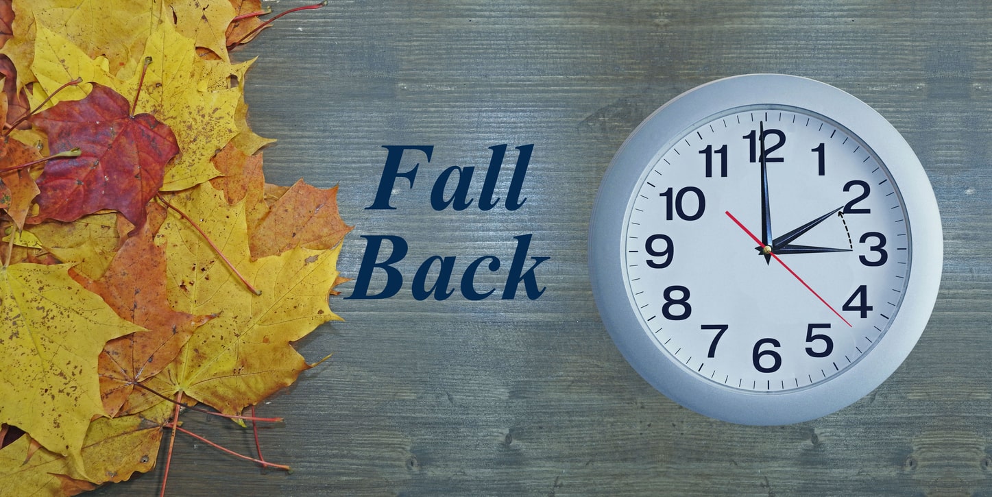 A wall clock is adjusted backward, symbolizing the transition to winter time during DST.