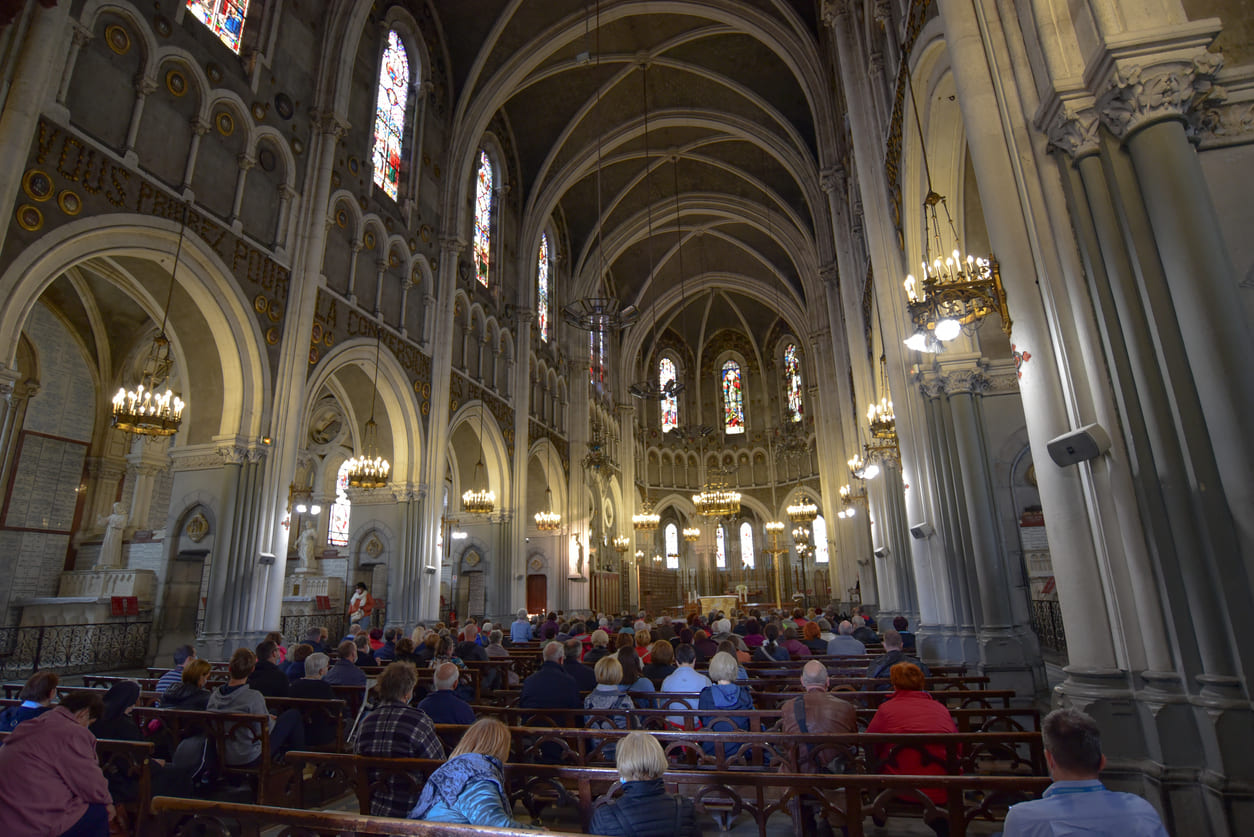 People gather for a solemn Ascension Day Mass inside the Rosary Basilica at Lourdes.