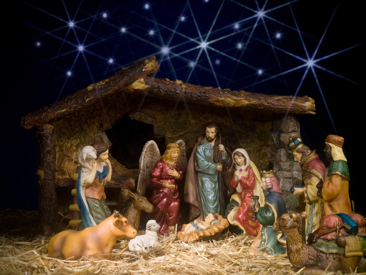 A detailed nativity scene with figurines depicting the birth of Jesus, surrounded by Mary, Joseph, angels, wise men, and animals.