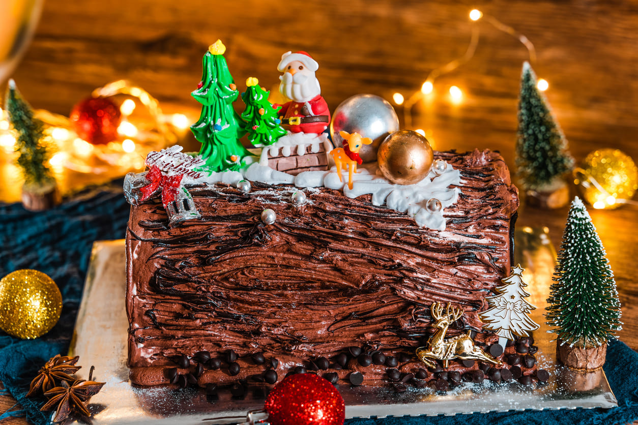 A beautifully decorated Bûche de Noël cake, capturing the festive spirit of Christmas Eve in France.