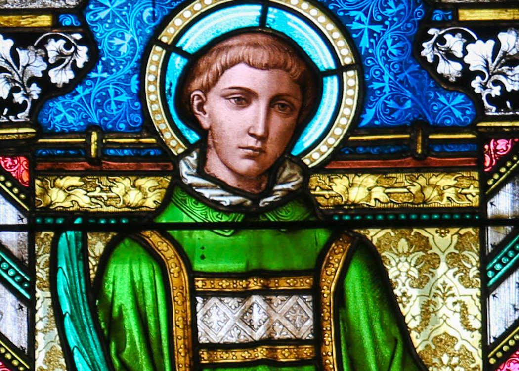 A stained glass portrait of Saint Stephen in green robes, reflecting his role as a dedicated deacon and early Christian leader.