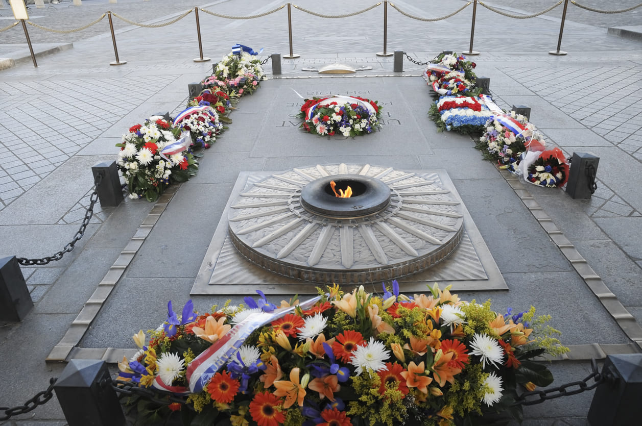 Wreaths and the Eternal Flame at the Tomb of the Unknown Soldier under the Arc de Triomphe honor fallen soldiers on Victory Day.