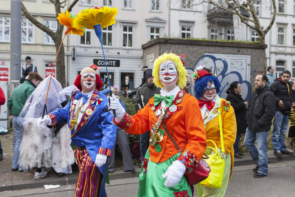 Festive participants in colorful costumes and cheerful makeup add excitement to the vibrant Carnival Tuesday celebrations in Germany.