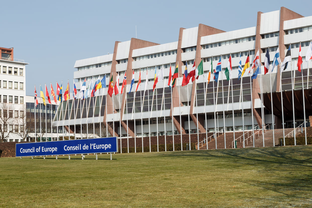 Palais de l'Europe in Strasbourg, France, adorned with the flags of its member states.