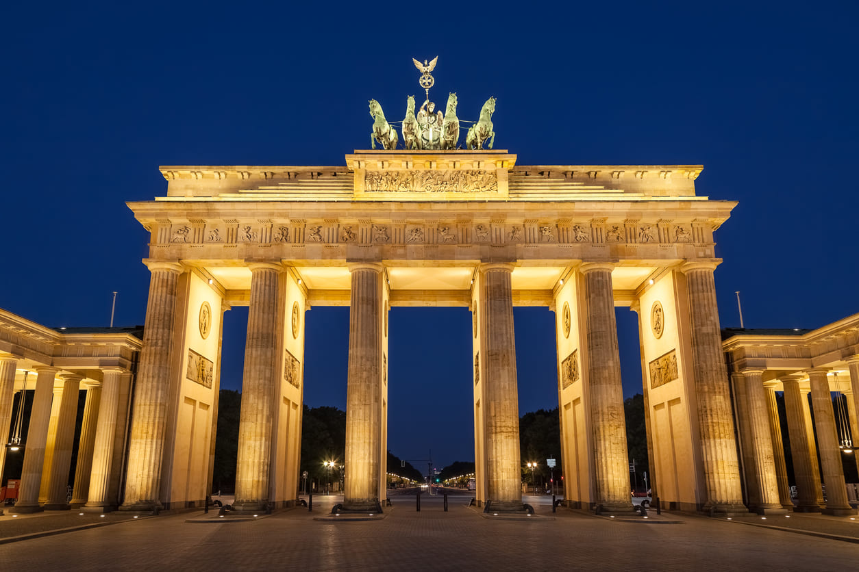 The Brandenburg Gate, beautifully illuminated at night, symbolizes Germany's unity and historical significance.