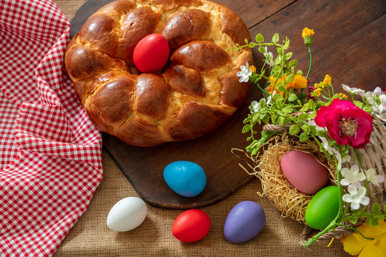 A traditional Easter display featuring Osterzopf (Easter bread) and colorful eggs, symbolizing the festive spirit of the season.