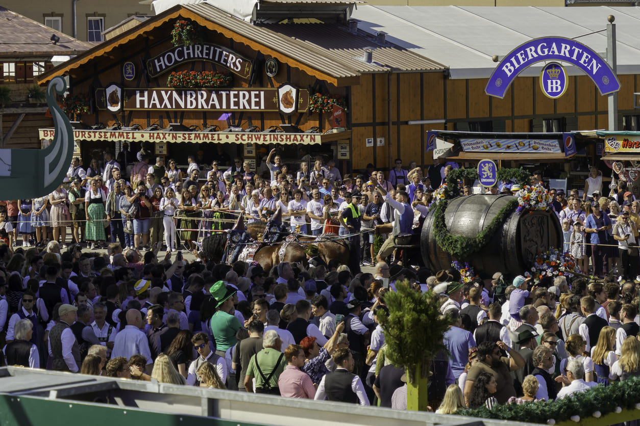 A lively crowd at Oktoberfest in Munich, showcasing traditional festivities and decorated beer wagons.