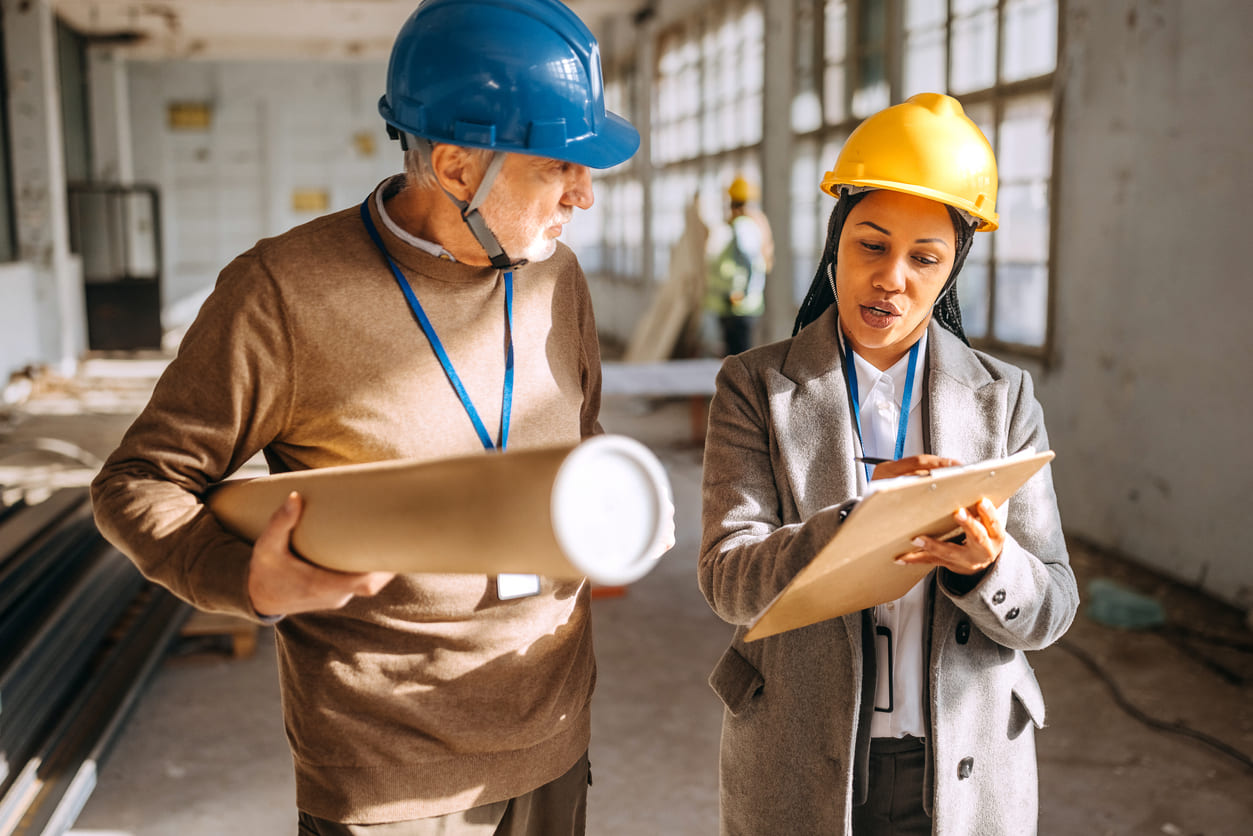 Professionals collaborating in a construction setting, symbolizing the spirit of breaking gender stereotypes and exploring new career opportunities.