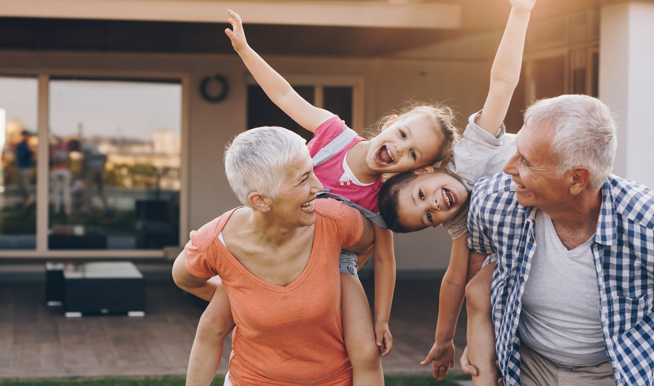 Grandparents joyfully playing with their grandchildren, capturing the warmth and love of family connections.