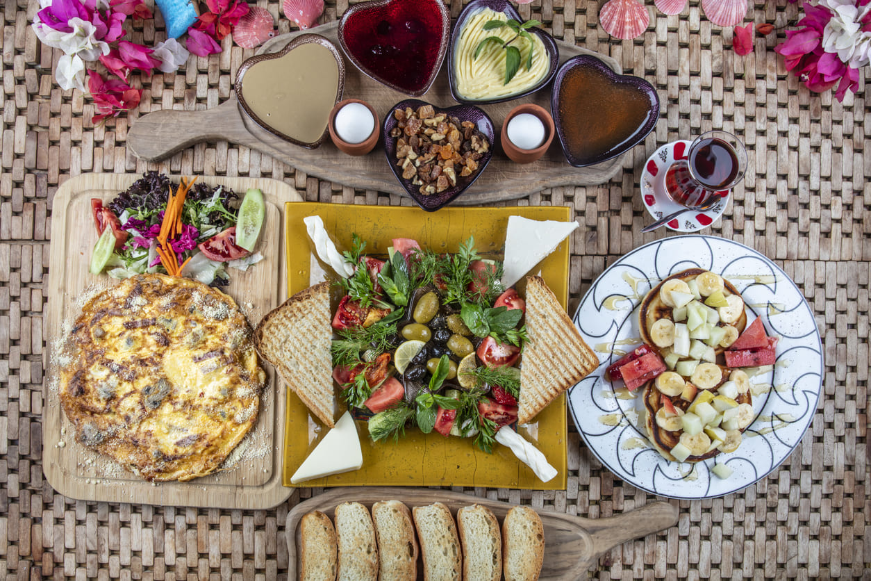 A colorful assortment of dishes and fresh ingredients, representing a communal meal shared during the Hizir Fast.