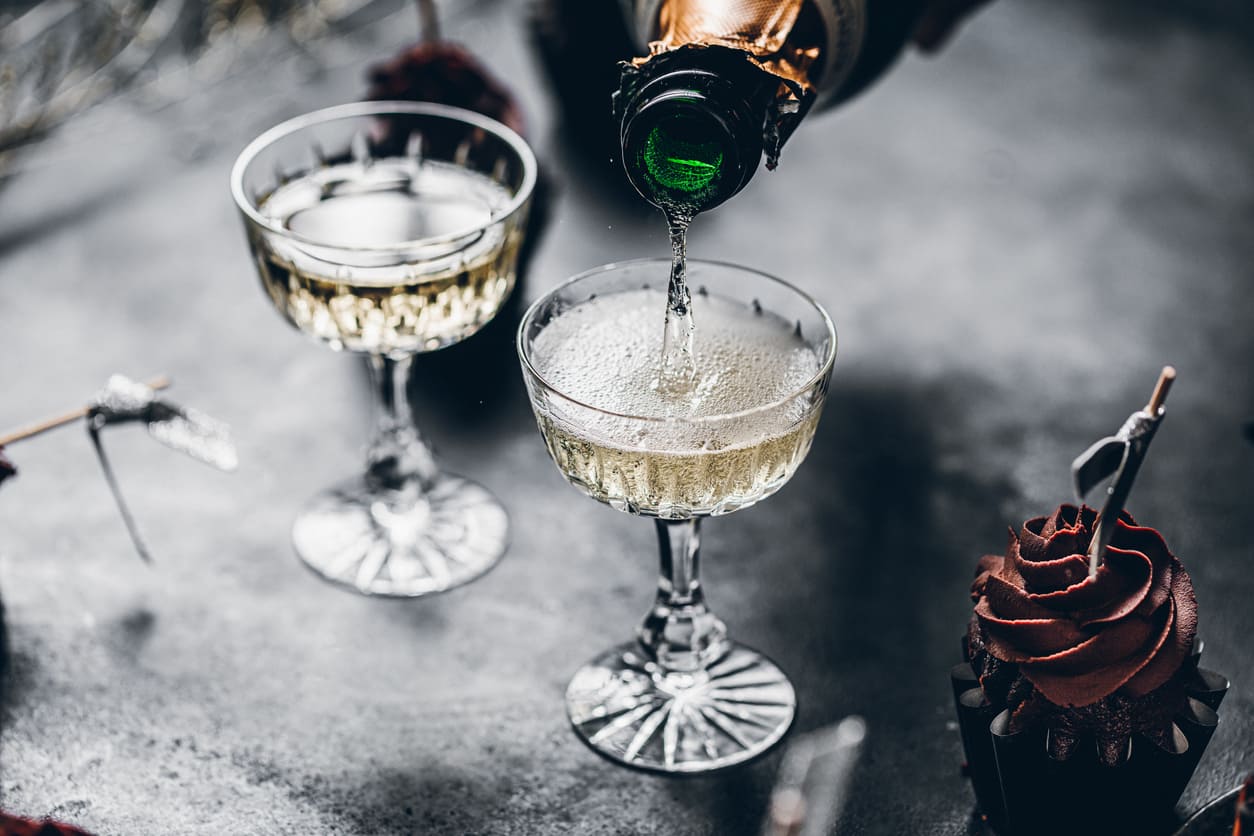 Glasses of champagne being poured, capturing the festive and celebratory spirit of New Year's Eve.