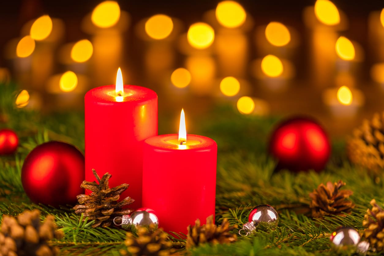 Two red candles lit on an Advent wreath, symbolizing the Second Advent Sunday.