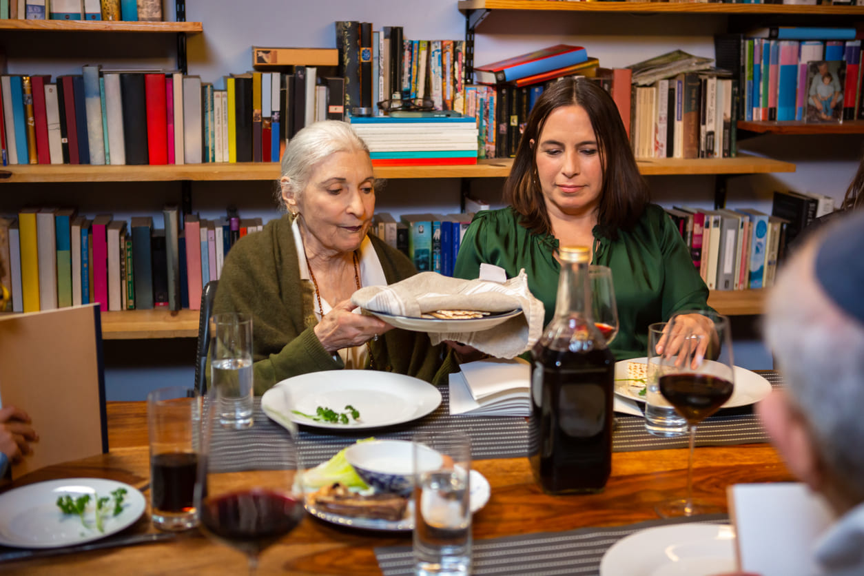 A family gathered around a table during the Passover Seder, sharing symbolic foods and traditions.