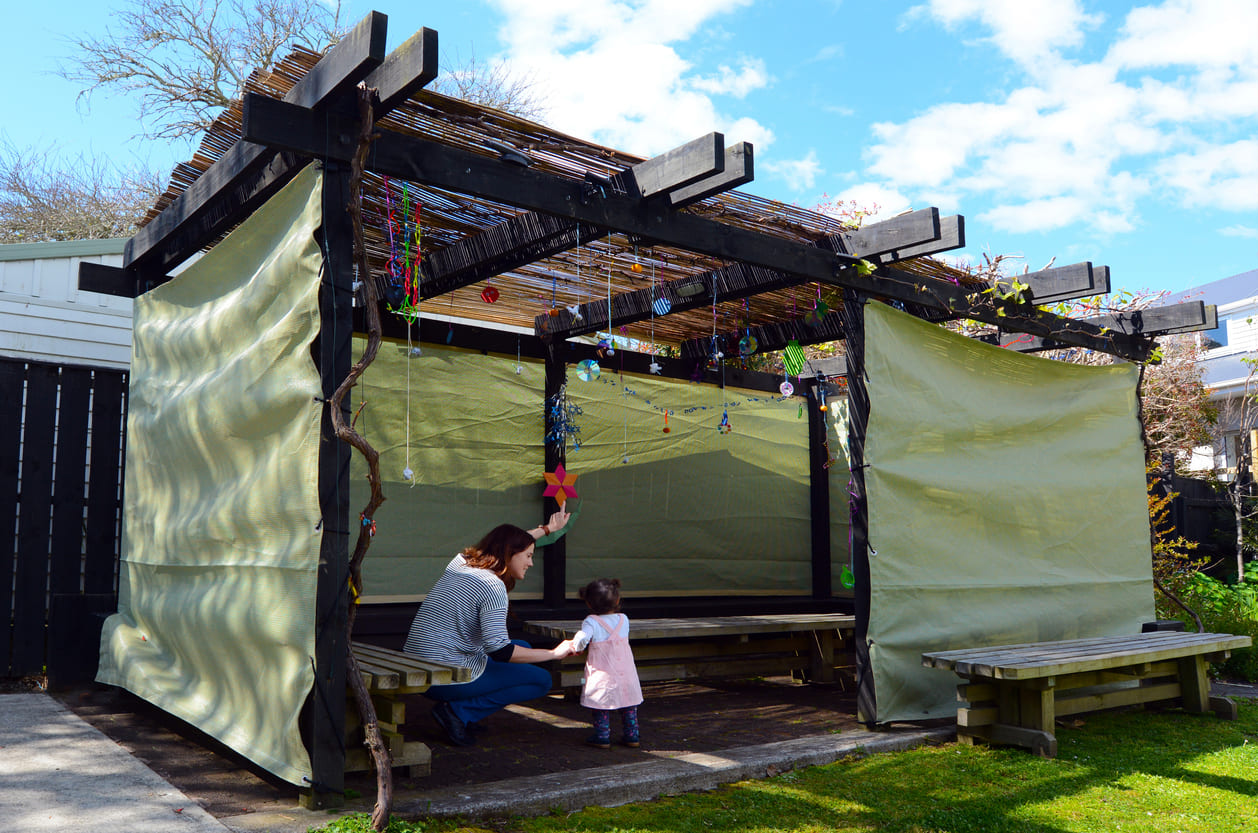 A family enjoying time in a beautifully decorated sukkah, a key tradition of the Sukkot festival.