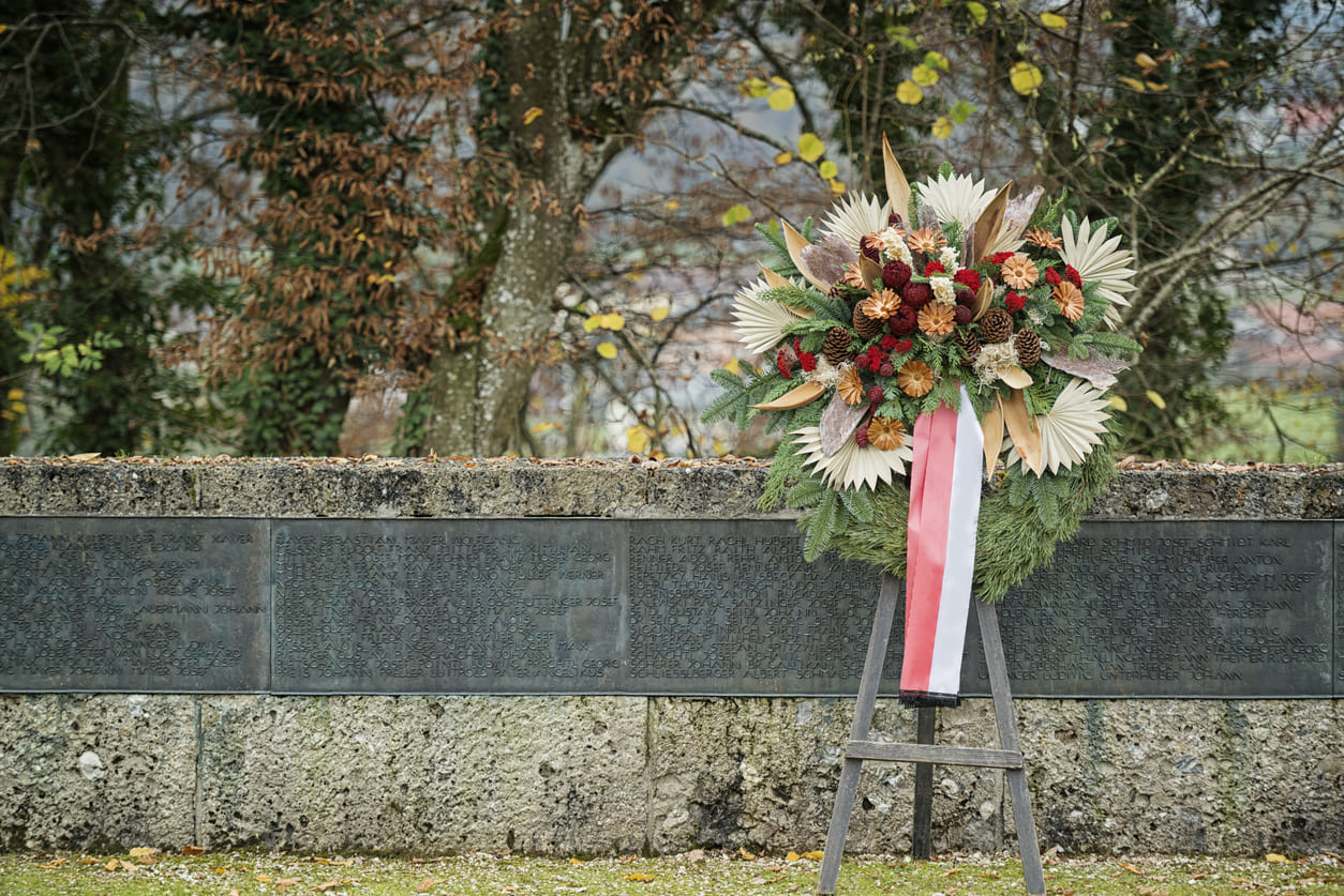 A wreath placed at a war memorial, symbolizing remembrance and respect for fallen soldiers.