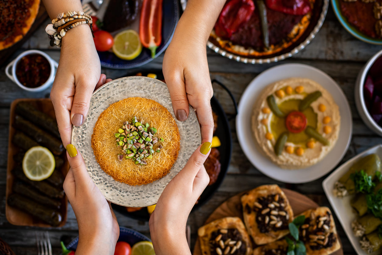 Sharing a traditional dessert, reflecting the spirit of generosity and celebration during Eid-ul-Fitr.