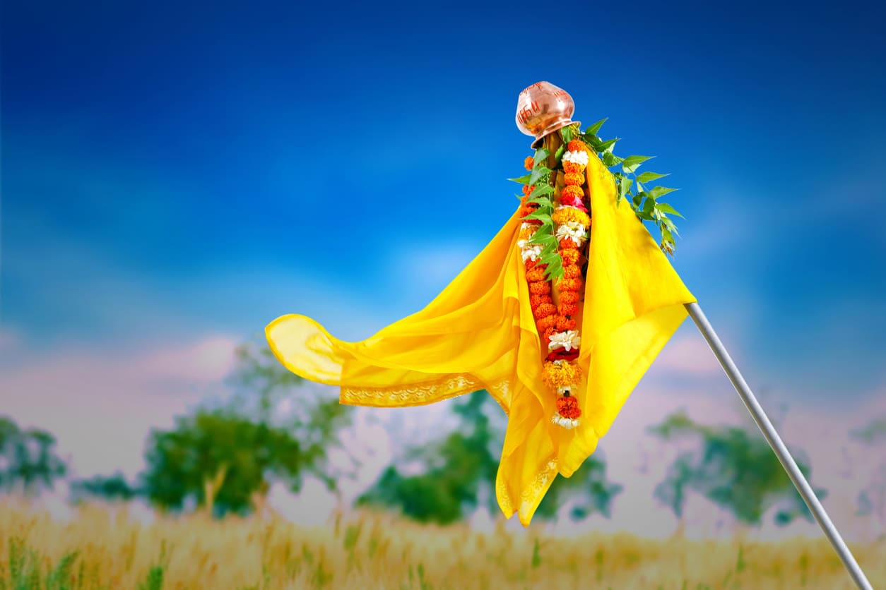 Beautifully decorated Gudi with a bright yellow cloth, flowers, neem leaves, and a copper pot, symbolizing prosperity and celebration.