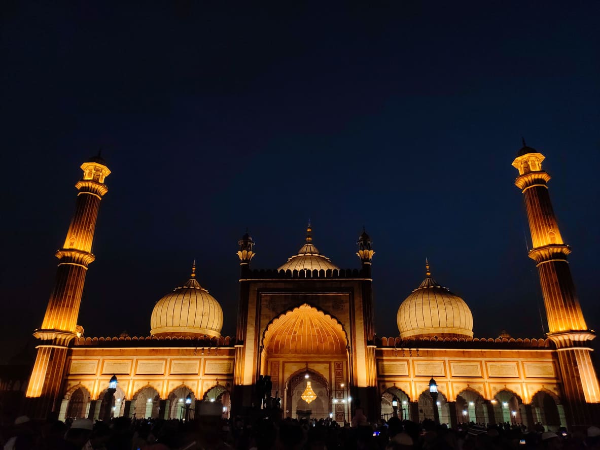 Jama Masjid beautifully illuminated against the night sky, symbolizing spiritual devotion and unity.