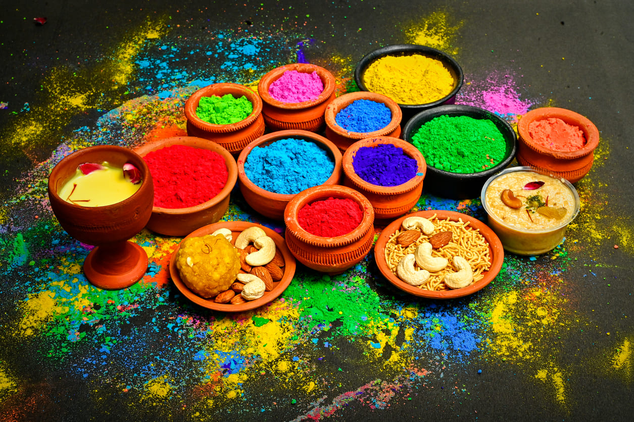 Vibrant Holi colors, traditional sweets, and festive drinks, capturing the essence of the celebration.