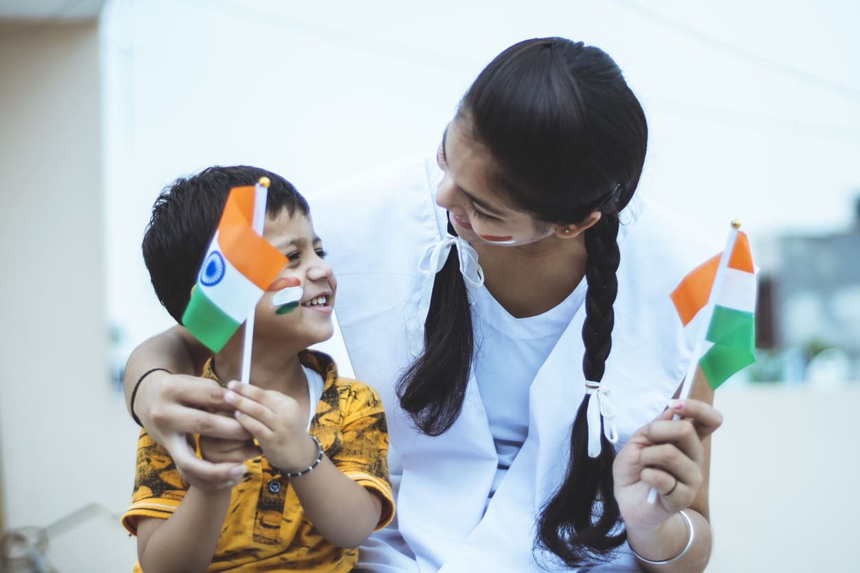 Young girl and child holding Indian flags, symbolizing patriotism and the joy of celebrating Independence Day.