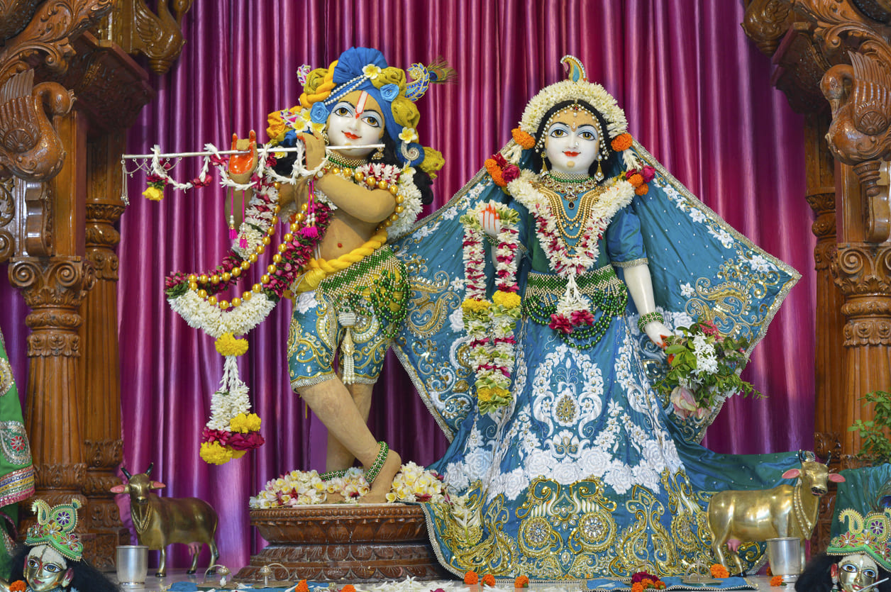 Intricately adorned idols of Lord Krishna and Radha, beautifully decorated for Janmashtami celebrations.