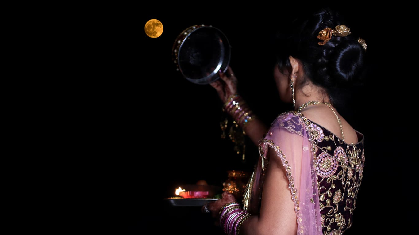 Karva Chauth ritual, where fasting is broken after sighting the moon through a sieve.