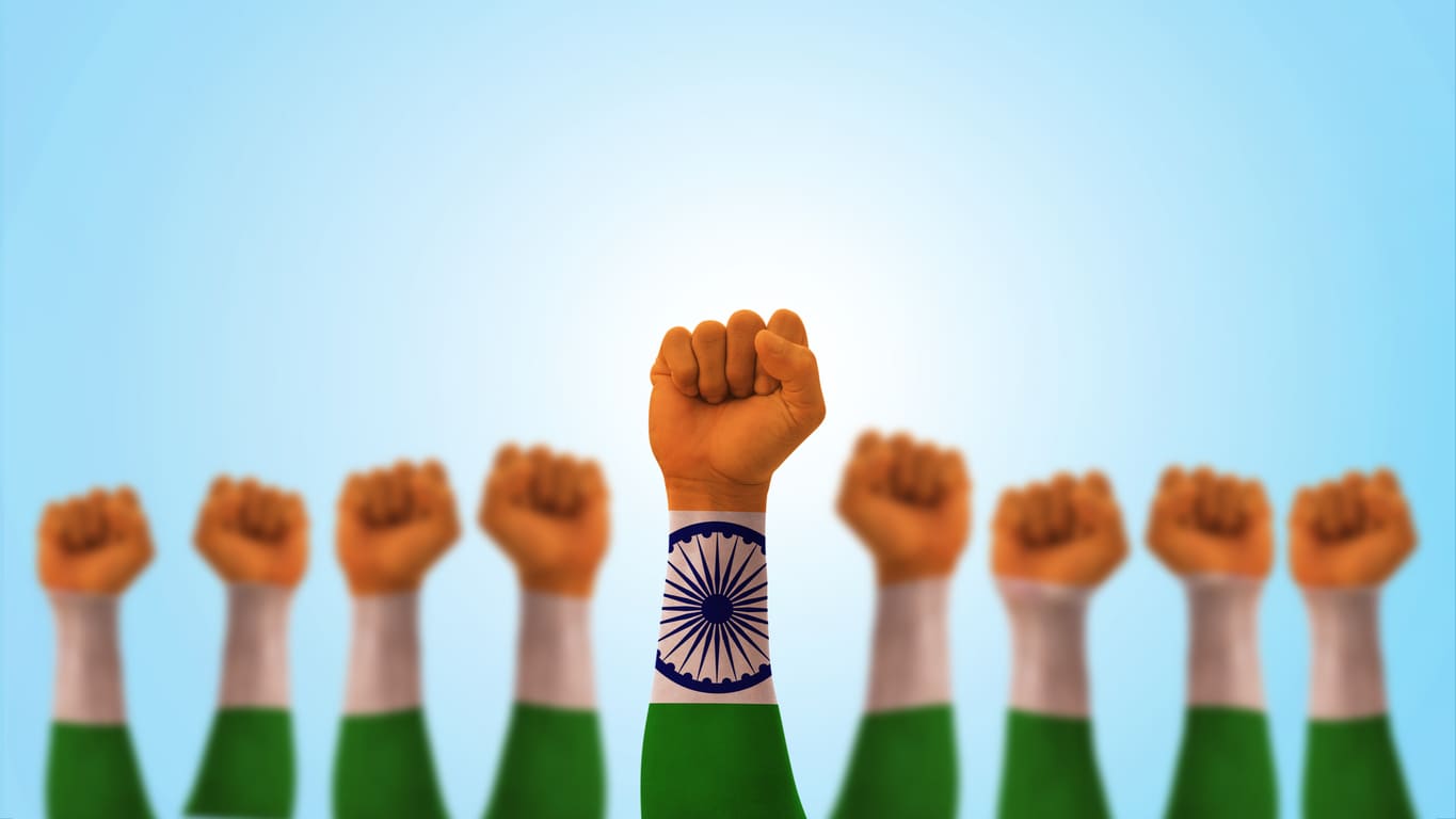 Raised fists with Indian flag colors, symbolizing unity and the collective fight for workers' rights and better conditions on Labour Day.