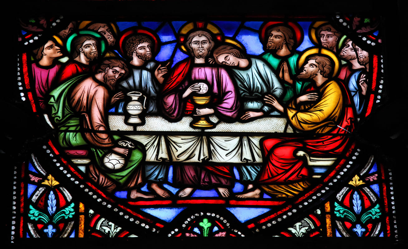 Vibrant stained glass depiction of the Last Supper, capturing Jesus Christ with his disciples during a sacred moment of communion.