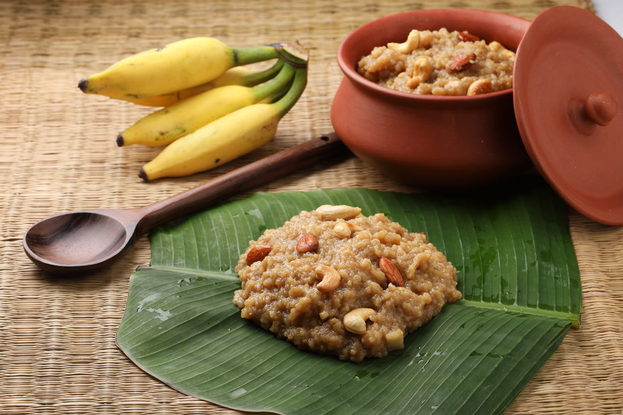 Sweet Pongal garnished with nuts on a banana leaf, symbolizing the Pongal festival's traditions.