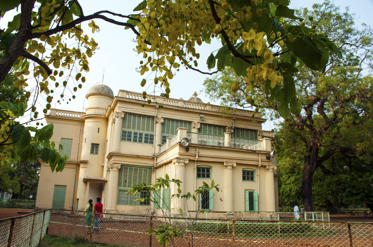 Rabindra Bhavan in Santiniketan, a historic building surrounded by lush greenery, symbolizing the legacy of Rabindranath Tagore.