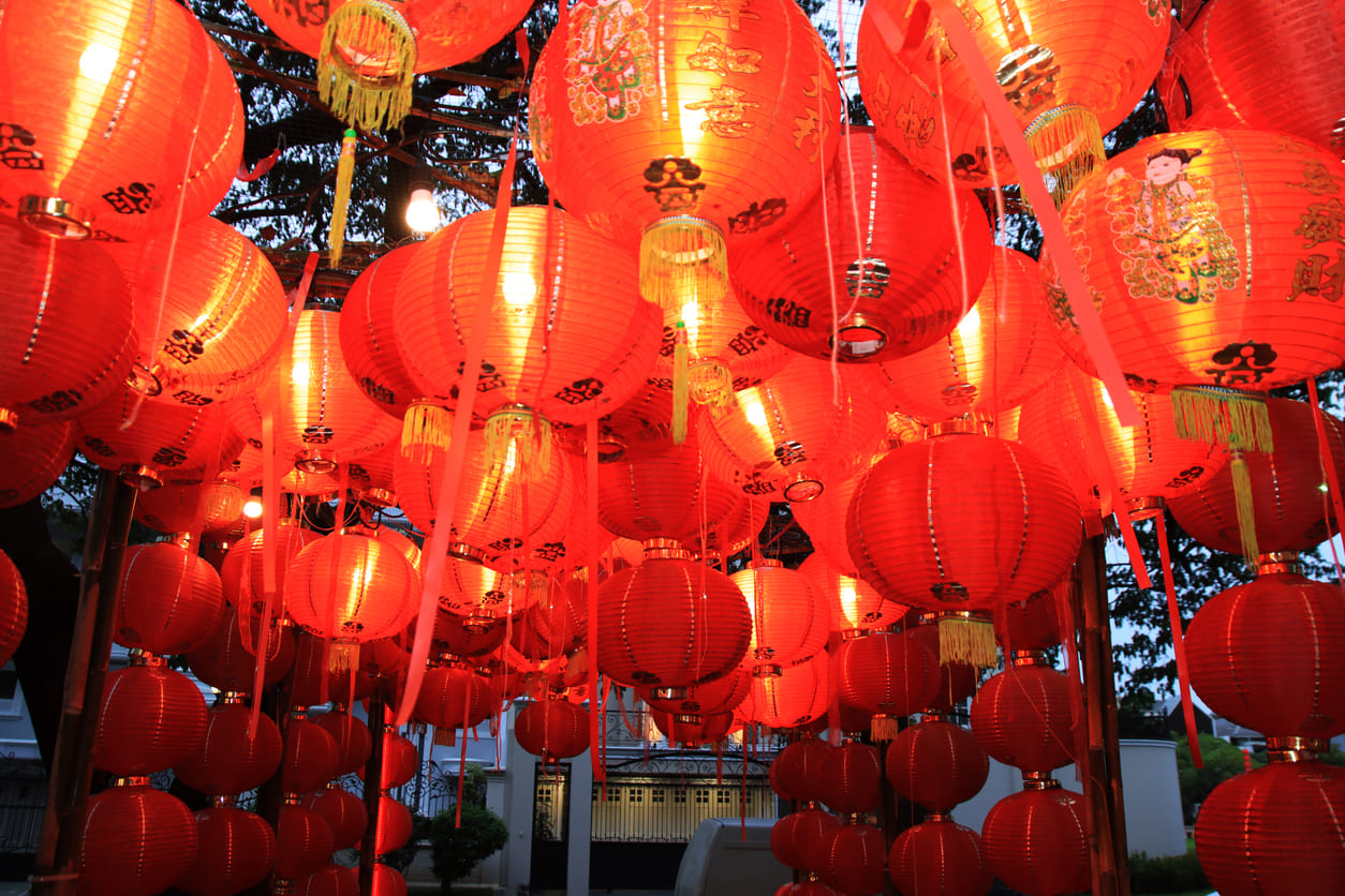 A cluster of glowing red lanterns hanging overhead, creating a festive atmosphere for Chinese New Year's Day celebrations in Indonesia.