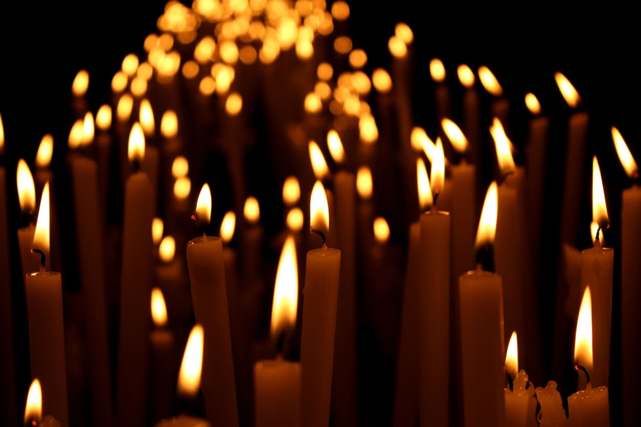 A serene display of glowing candles, symbolizing light, hope, and reflection in a solemn atmosphere.