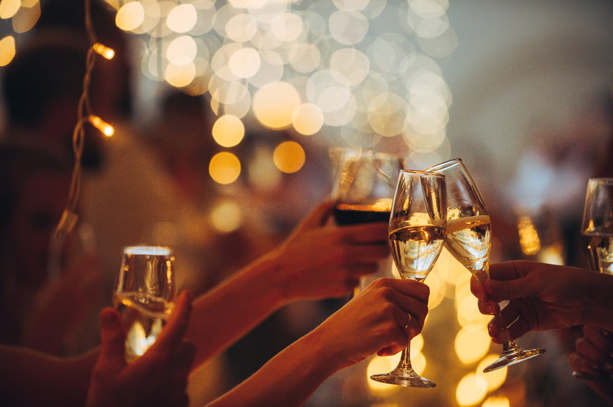 Glasses clink in celebration as people toast to hope, joy, and new beginnings on New Year's Eve.