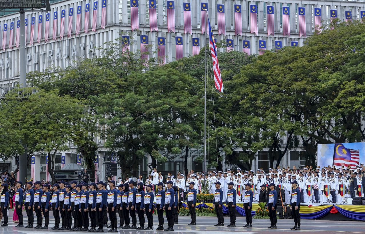 Participants march in the National Day parade in Putrajaya, showcasing Malaysia's patriotism and national pride.
