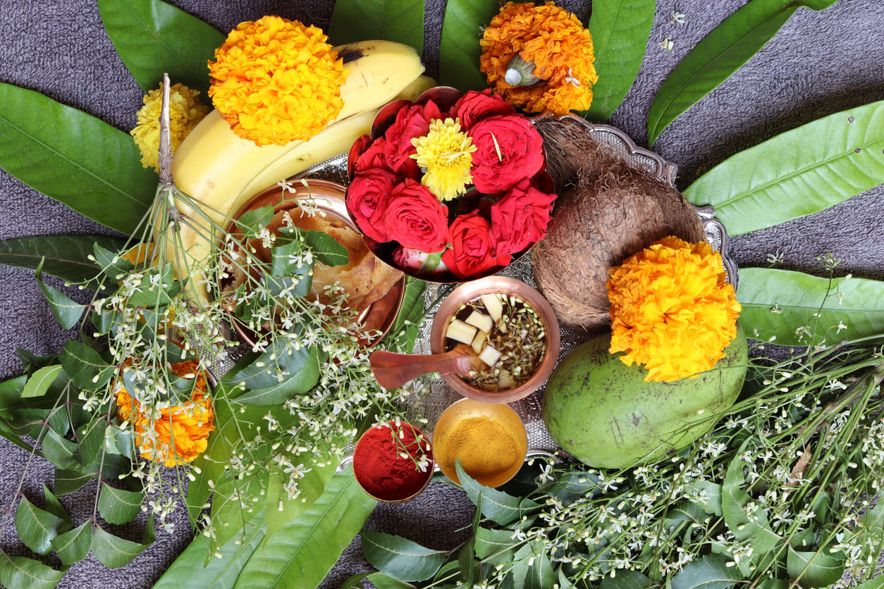 A colorful display of Ugadi Pachadi, flowers, fruits, and sacred leaves, capturing the essence of Ugadi celebrations in Mauritius.