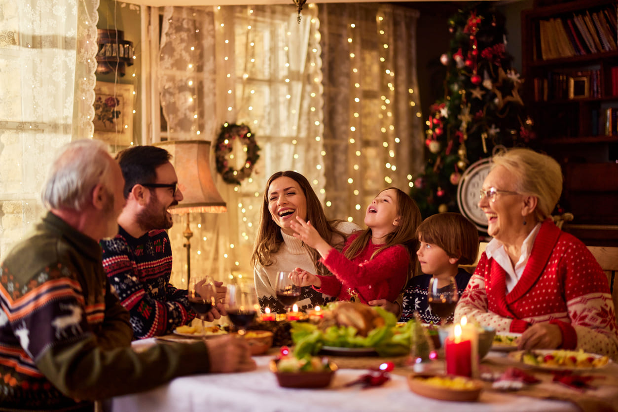 A festive family dinner surrounded by warm lights and holiday decorations, capturing the joy of Christmas Eve.