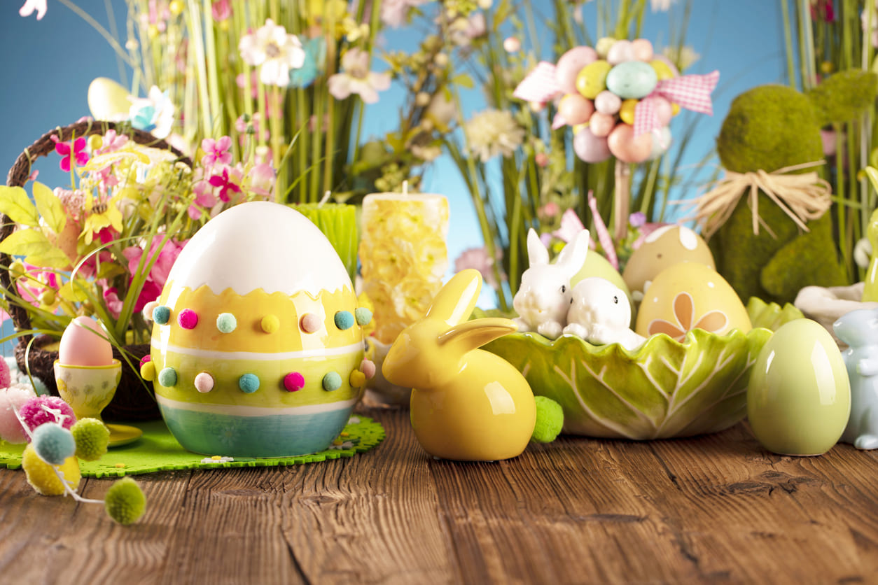 A vibrant display of Easter decorations featuring colorful eggs, playful bunnies, and fresh spring flowers.