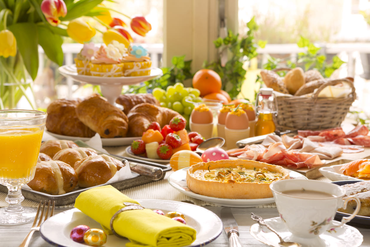 A colorful and inviting Easter brunch table filled with festive treats, vibrant decorations, and fresh spring elements.