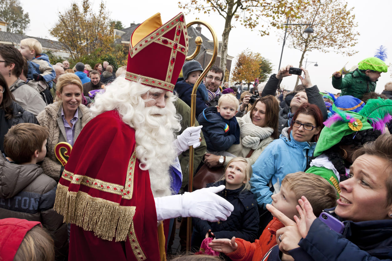 Sinterklaas engages with cheerful children and families, embodying the joy of Dutch holiday traditions.