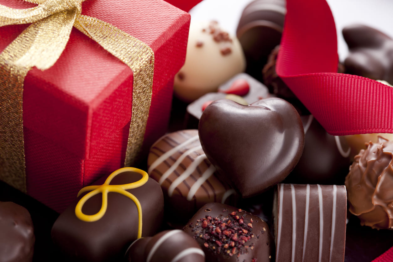 A close-up of chocolates and a wrapped gift, symbolising the sweet and thoughtful exchanges of Valentine's Day.