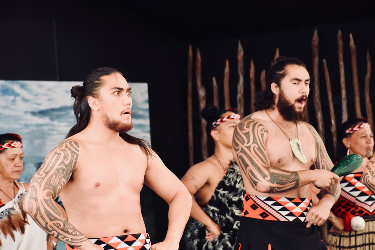 A dynamic group of Māori performers captivating the crowd with a traditional kapa haka during Waitangi Day celebrations.