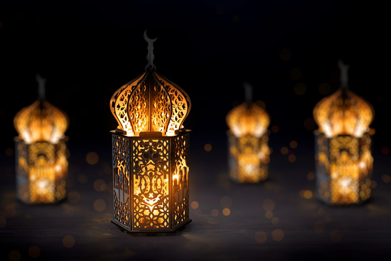 Arabic lantern glowing on dark background on occasion of Muharram