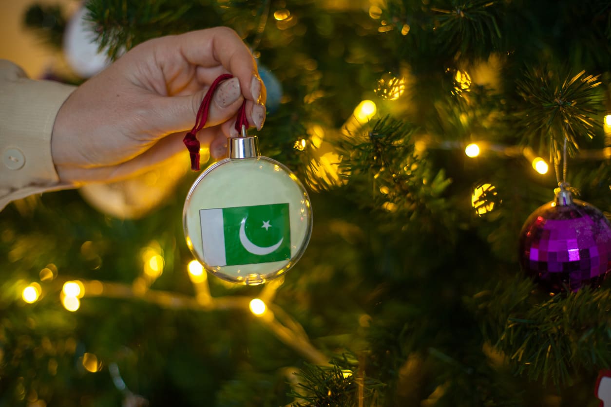 Christmas tree adorned with lights and ornaments, reflecting the festive traditions of Christmas in Pakistan and worldwide.