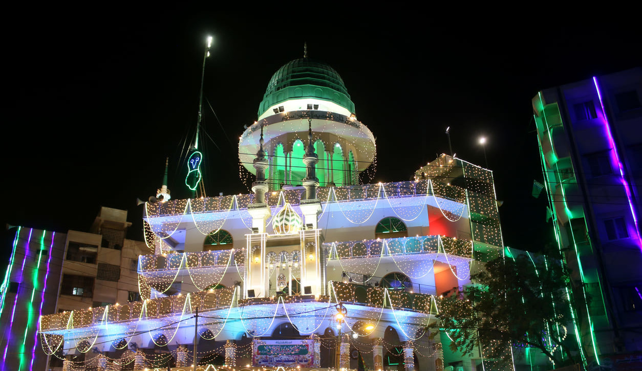 A mosque in Karachi beautifully adorned with colorful lights, celebrating Eid Milad-un-Nabi with festive grandeur.